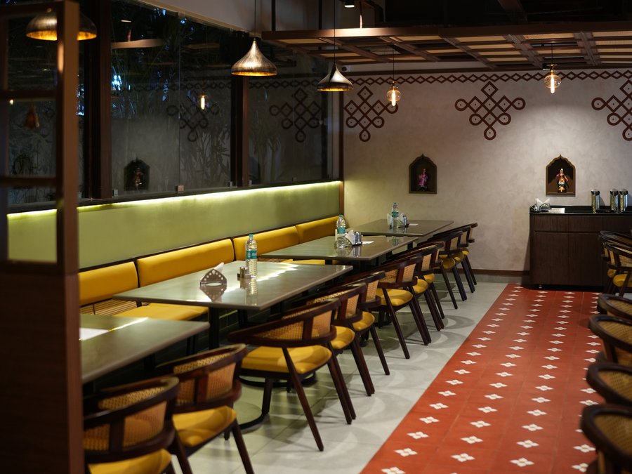 Mustard banquettes along the green-lit wall